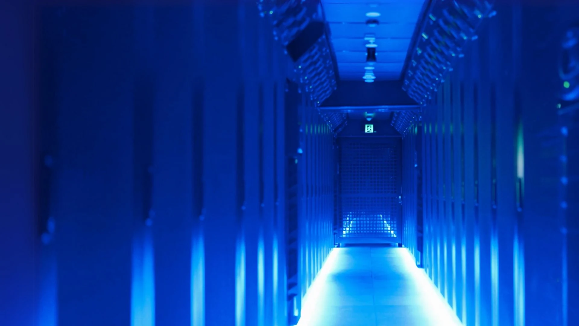 Blue-lit server aisle at Micron21